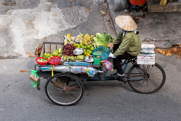 Fototapeta na wymiar Fruits and vegetables seller on a bicycle in Vietnam