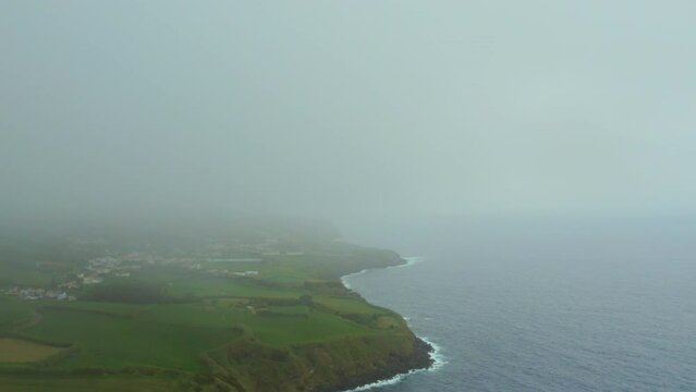Aerial shot, drone point of view rocky coastline, Atlantic Ocean coastline of Island of Sao Miguel, Azores, Portugal. Travel destinations and beauty in nature concept