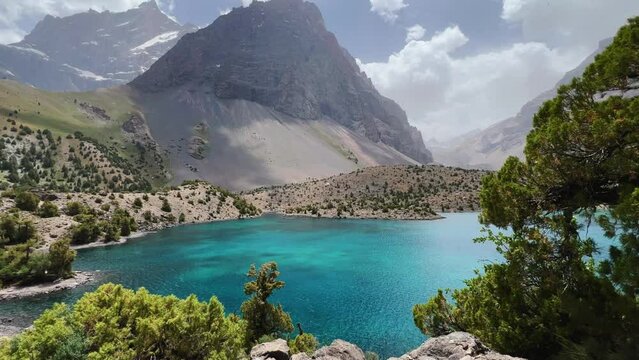 The Alaudin (Chapdara) lakes, lying at an altitude of 2800 m, are considered one of the most beautiful lakes of the Fan Mountains. Turquoise mountain lake. Pamiro-Alai. Tajikistan, Pamir 4K