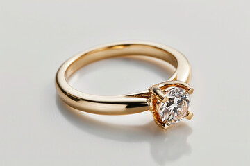 gold engagement ring with diamond gemstone, on white background