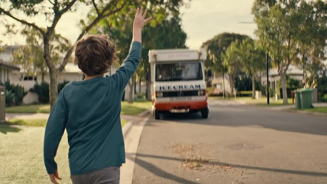 Little kid waving to the coming ice cream truck