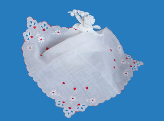 Red hearts on white fabric handkerchief allows center text space.  The display is crowned with a cupid figure in white. Delicate eyelet trim & edging give image a romantic dreamy valentine feel.
