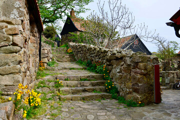 old stone wall and house