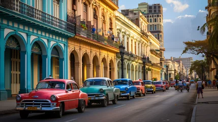 Fotobehang A lively street scene in Havana Cuba with colorful vintage cars and colonial architecture. © Sebastian