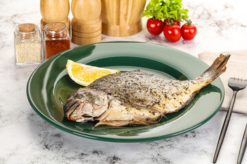 Baked Dorado fish served lemon