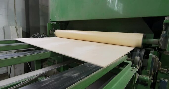 Automated production of plywood sheets at the factory. Finished veneer sheets. Plywood production