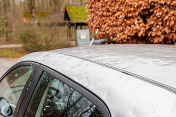 Roof of a silver-coloured vehicle with significant hail damage