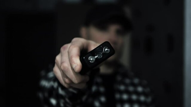 Stun gun in a man's hand, electric discharge, portable shocker, dog repeller