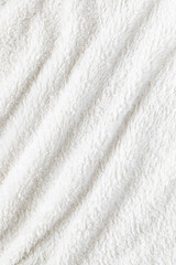 White plush fabric of cozy throw. Warm blanket background