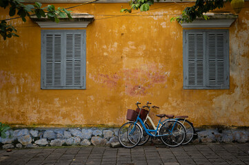 The yellow stuccoed buildings of Hoi, An, the Unesco Wold Heritage Site with two bicycles