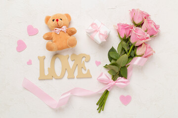 Pink roses with hearts and gifts on concrete background, top view. Valentines day concept