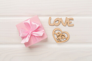 Valentines day composition with gifts on wooden background, top view.