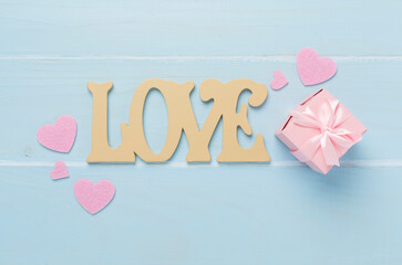 Valentines day composition with gifts on wooden background, top view.