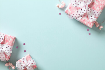 St Valentine's Day flat lay composition with pink gift boxes, hearts, confetti on turquoise background. Top view with copy space. - Powered by Adobe