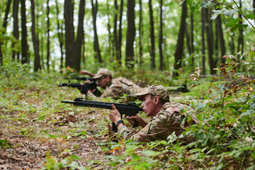 Elite soldiers stealthily maneuver through the dense forest, camouflaged in specialized gear, as they embark on a covert and strategic military mission