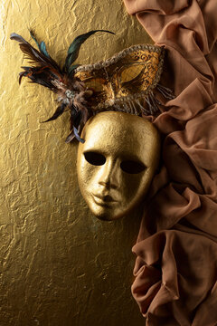 Vintage Venetian carnival masks masks on a golden background.