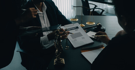 Judge gavel with Justice lawyers having team meeting at law firm background. Concepts of Law and Legal services.