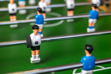 Fototapeta premium Close-up of blue and white football players playing table football