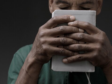  black man praying to god with black grey background with people stock image stock photo