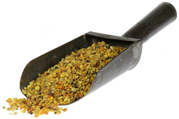 organic bee pollen in a metal weighing scoop isolated on white background