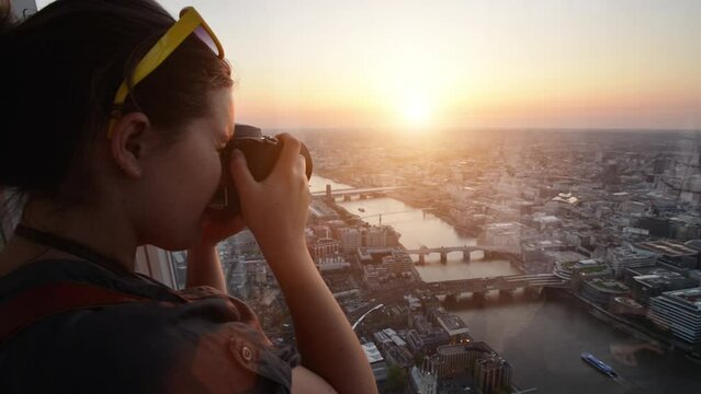 Woman photographer, city and picture with sunrise, drone and photo in morning, new york and holiday. Travel, vacation and camera for skyline view, capture and photography with cityscape for tourism