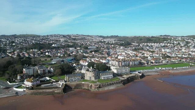 Paignton, Torbay, South Devon, England: DRONE VIEWS: The town of Paignton and its suburban houses; Preston Sands (right); Seafront hotels; Beach with walkers; Paignton Green (left) & seafront (Clip 1)