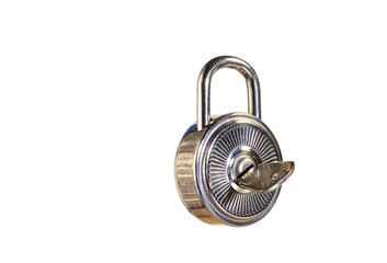 An image on a white background of a round shiny padlock with a key.