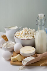 Assortment of fresh dairy products, milk, cottage cheese, cheese, cream cheese, butter, eggs and...