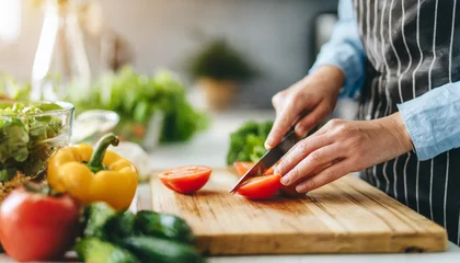 Fotobehang woman joyfully prepares a nutritious meal in a bright kitchen, embodying health and wellness with fresh ingredients and vibrant cooking © Your Hand Please