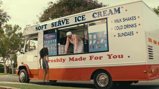 Little girl rushing to the ice cream truck to buy ice cream