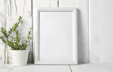 Wooden table with empty white frames over white wall