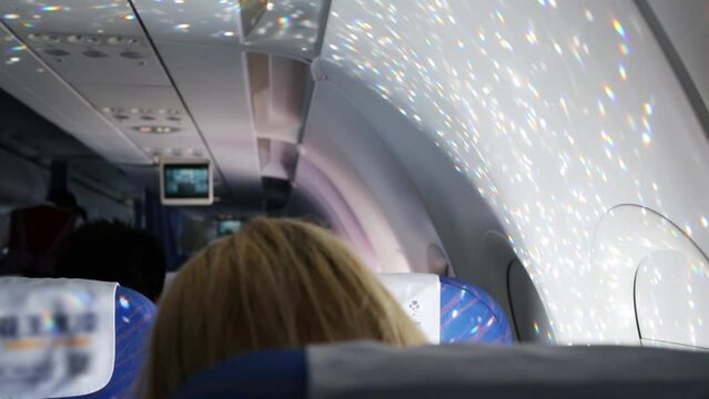 Heads of passengers of flying aircraft, illumination in aircraft cabin