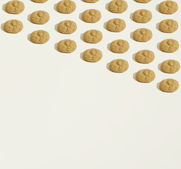 A pattern made of almond cookies geometrically laid out on a dark beige background. Copy space. Sweets minimal concept.
