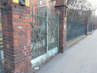 Old brick and metal fence.