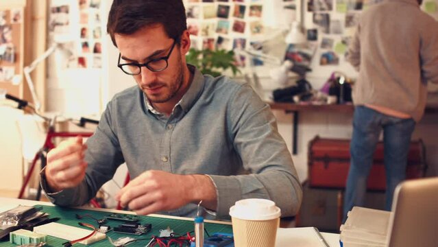 IT, engineer and man working on motherboard, tools and circuit analysis with ideas and solution. Design, circuit board and desktop expert looking at wires, thinking and problem solving with equipment