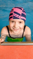 Portrait of a little girl in indoor swimming pool