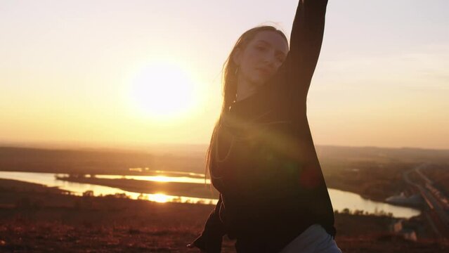 Girl dancing against the background of a river