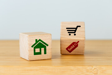 Obraz na płótnie Canvas Buying a house or apartment, Real estate purchase symbol, Housing concept, Wooden blocks with house, shopping cart and word Sold icons