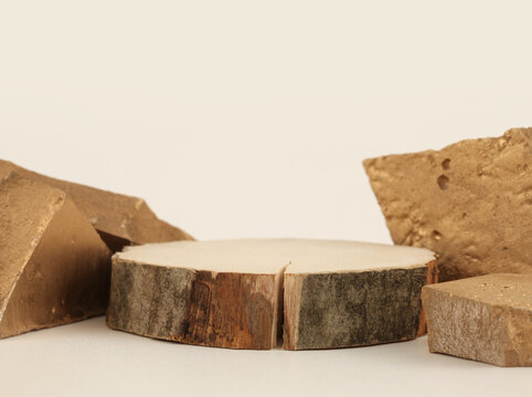 Stones, Wooden disc platform  on light beige background. Minimal empty display product presentation scene.