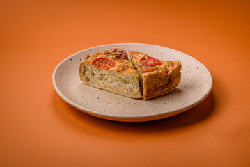 Delicious quiche with tomato, cheese, chicken, spices and herbs