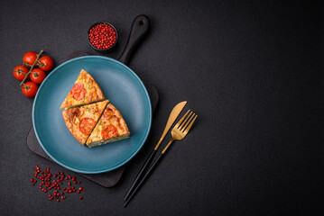 Delicious quiche with tomato, cheese, chicken, spices and herbs