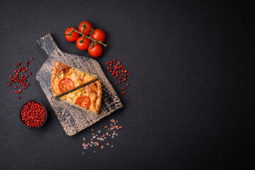 Delicious quiche with tomato, cheese, chicken, spices and herbs