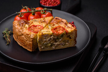 Delicious quiche with tomato, cheese, chicken, spices and herbs
