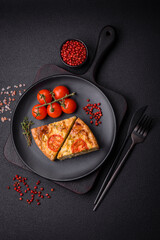 Delicious quiche with tomato, cheese, chicken, spices and herbs