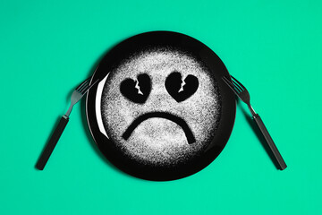 Sad face, face I don't like, concept made with plate and flour, light green background, heart...