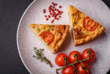 Delicious quiche with tomato, cheese, chicken, spices and herbs