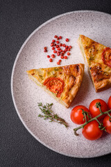 Delicious quiche with tomato, cheese, chicken, spices and herbs