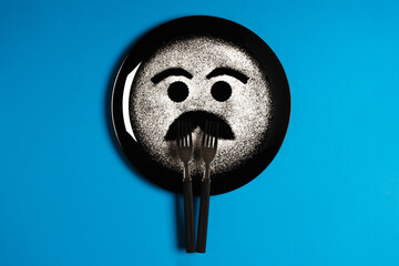 Happy face, face with mustache, concept made with plate and flour, blue background, black plate, facial expressions, forks in the shape of arms with different positions