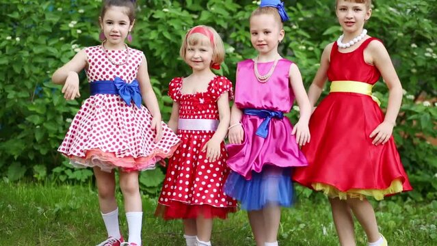 Four girls in row clapping themselves on legs simultaneously