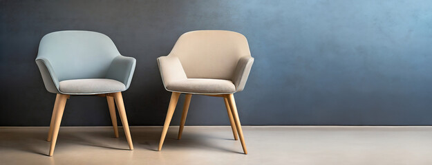 Modern Chairs Against a Textured Wall. Two stylish chairs, one blue and one beige, sit on a smooth...